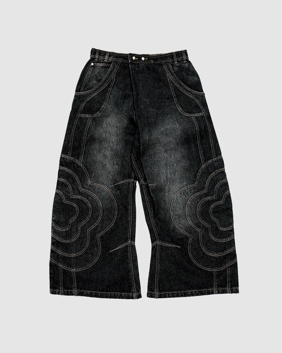 The BLACK MOCHI PANELED PANTS (x JOONIVERSE) by Sundae School are unisex, wide-leg black denim jeans with bold, curved cloud-like stitching on the front, button closure, and belt loops, shown on a light gray background.
