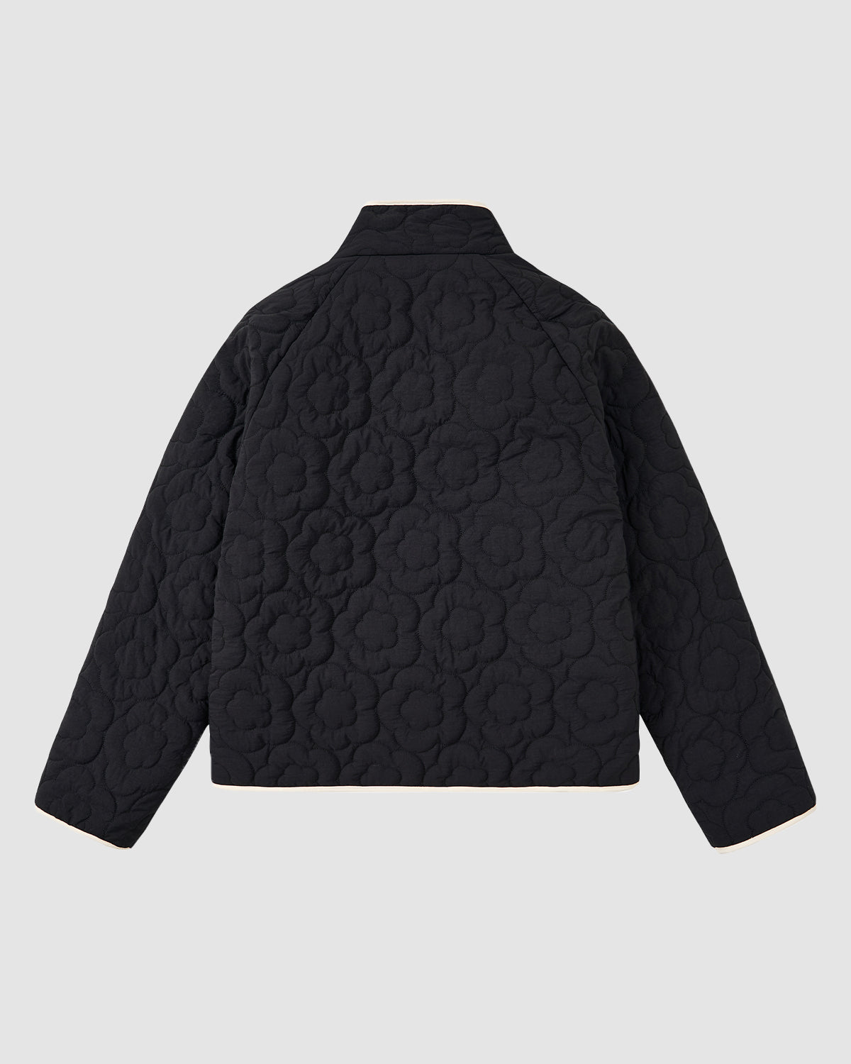 The BLACK IVORY REVERSIBLE FLOWER QUILTED JEOGORI FLEECE by Sundae School, featuring a floral embossed pattern inspired by the Korean hanbok jacket, is shown from the back against a plain light gray background.