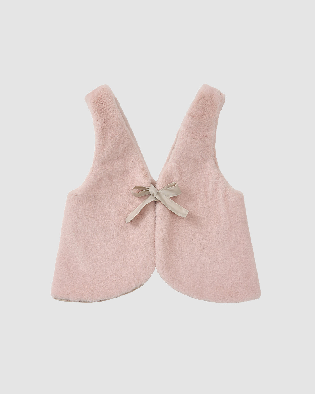 The SILVER PINK BAEJA VEST / BAG by Sundae School is a soft, sleeveless light pink faux fur vest with a rounded hem and beige ribbon bow at the back, displayed flat on a white background.