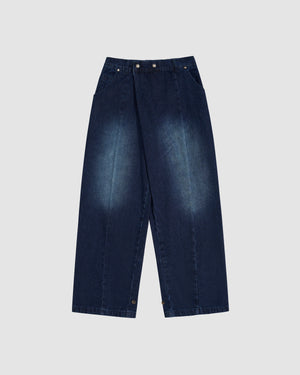 Indigo fade wide-leg hanbok denim pants with high-rise waist and asymmetric front closure featuring silver flower-shaped snap buttons, relaxed fit silhouette, flat lay photography on light gray background