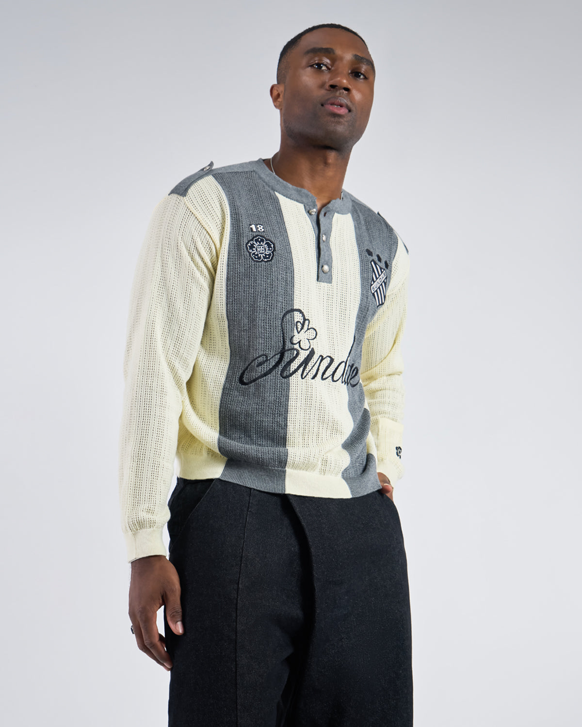 Butter Yellow Charcoal Sundae Soccer Jersey Knit modeled showing three-quarter angle view with vertical striped pattern, ribbed knit texture, henley placket with snap buttons,