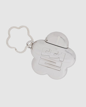 Sundae School Silver Mochi Lighter Case in silver featuring mochi flower shape with Korean "떨" logo engraved on front, hinged opening, attached to silver flower-shaped keychain, flat shot on light gray background.