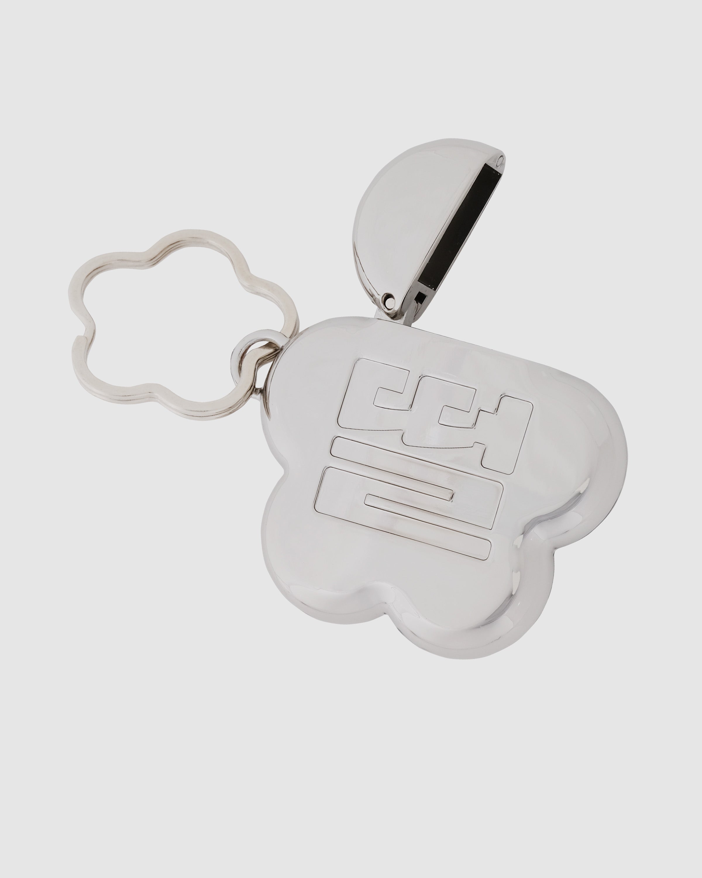 Sundae School Silver Mochi Lighter Case shown open revealing black lighter inside mochi flower-shaped case, attached to silver flower-shaped keychain with metal ring, flat shot on light gray background.