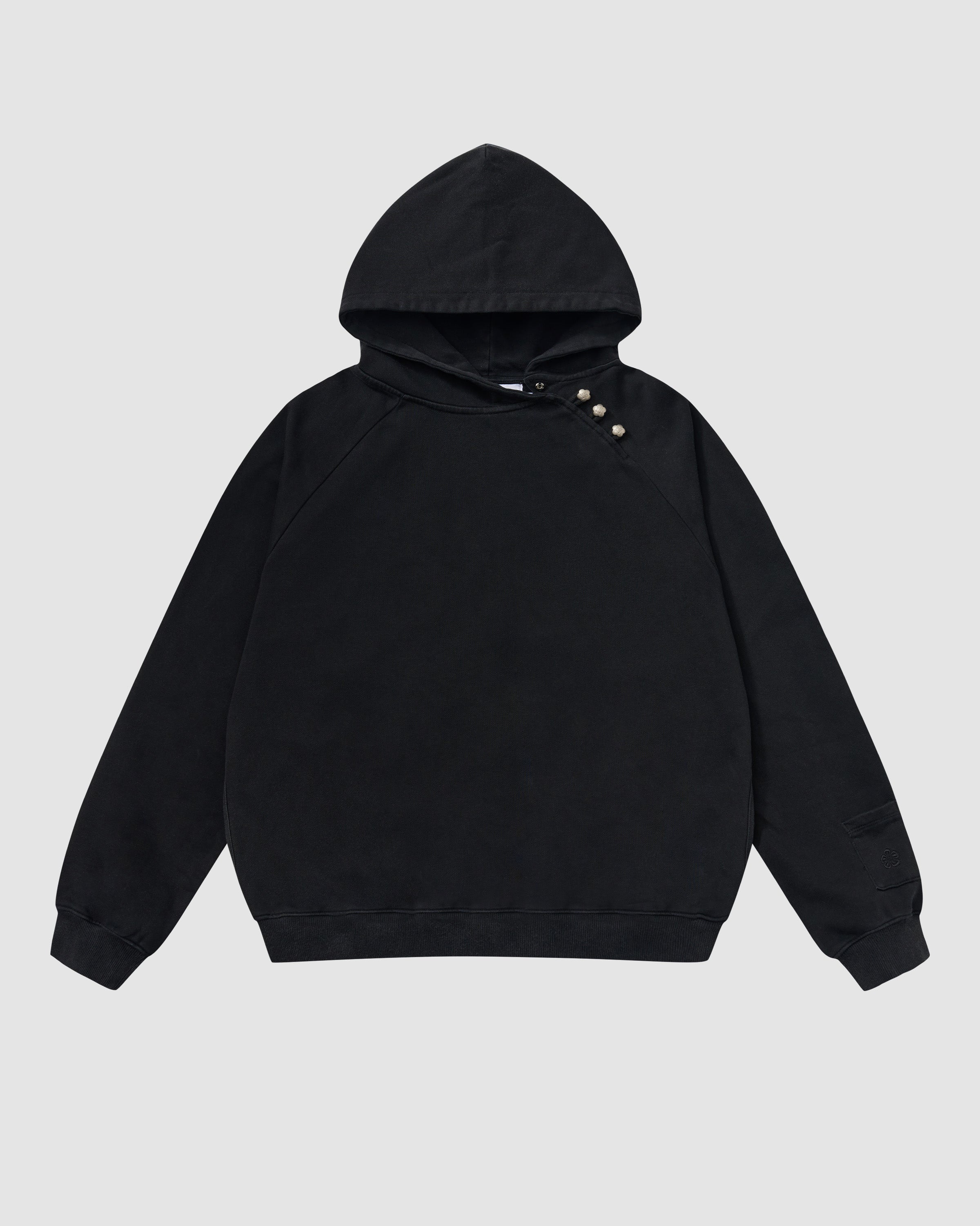 Black Fade Black Hanbok Hoodie featuring garment washed black cotton with custom dome snap hardware on hood, asymmetric closure design, pullover construction with kangaroo pocket, relaxed oversized fit silhouette, flat lay product shot on light background.