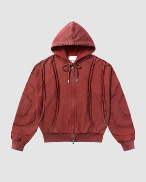 Red Mochi Haze Paneled Hoodie featuring garment washed red cotton with exposed curved seam details throughout body and sleeves, zip-up construction with drawstring hood, ribbed cuffs and hem, relaxed oversized fit silhouette, flat lay product shot on light background.