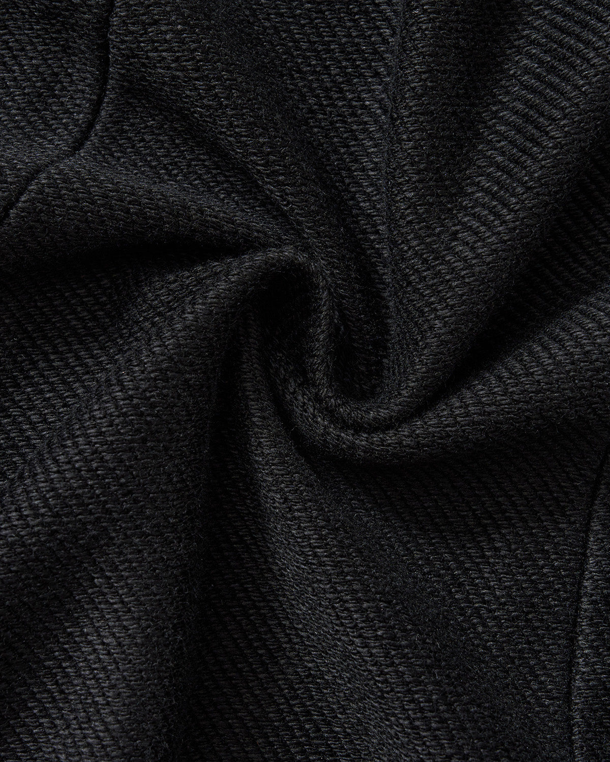 Black Mochi Haze Paneled Hoodie fabric texture detail showing washed black fleece material with subtle ribbed texture and natural fabric draping, close-up macro shot.
