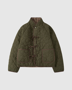 Olive green quilted Reversible Flower Quilted Jeogori Fleece with circular flower pattern quilting throughout, featuring brown trim, two front pockets, and asymmetrical tie closures down the front.