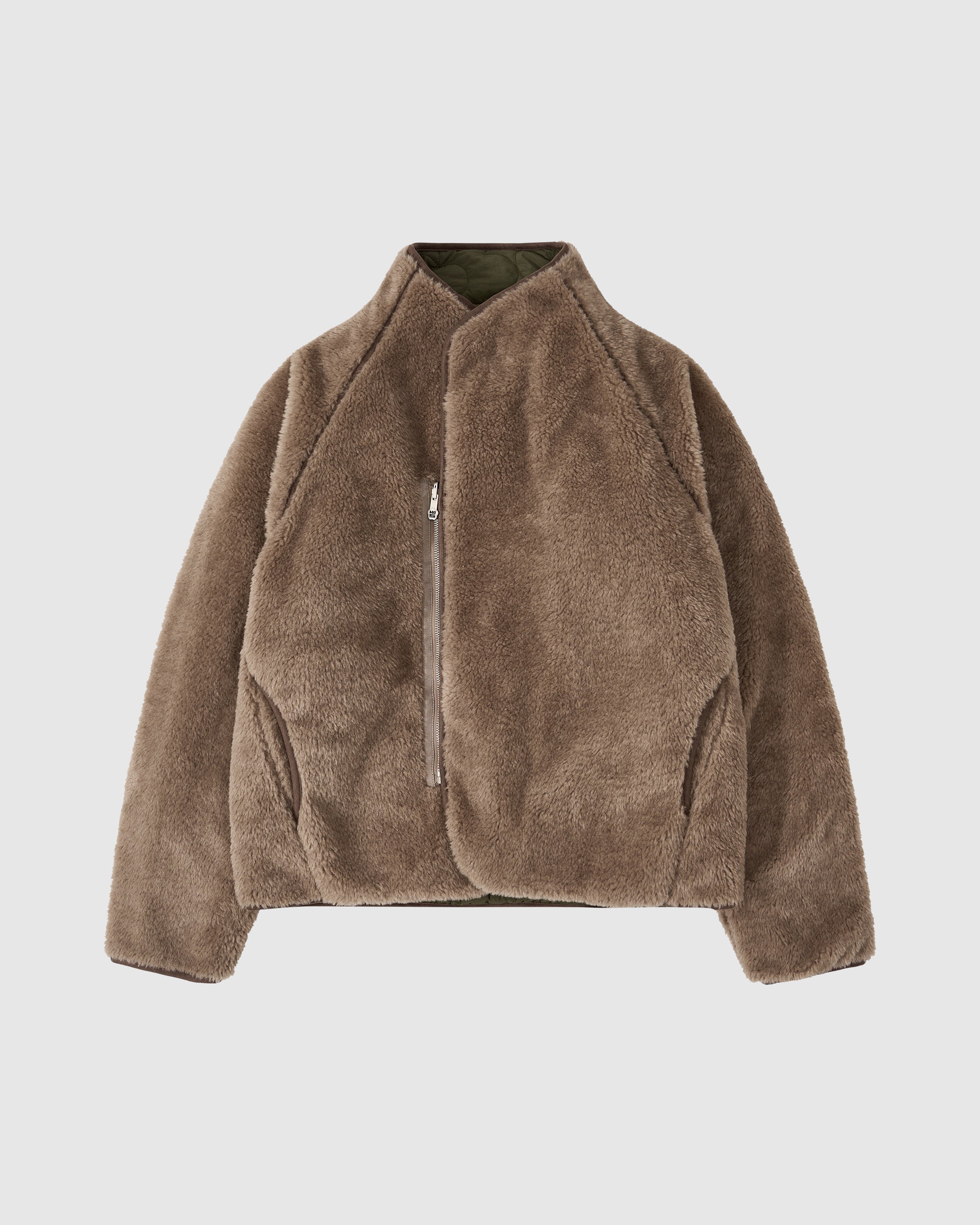 Brown teddy fleece side of the Reversible Flower Quilted Jeogori Fleece with textured sherpa material, featuring a high collar and olive green lining visible at the collar.