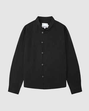 The Sundae School BLACK CHINA COLLAR KNOT SHACKET, a long-sleeved black button-up with a mandarin collar, is displayed flat on a light gray background with a visible white label inside the collar.