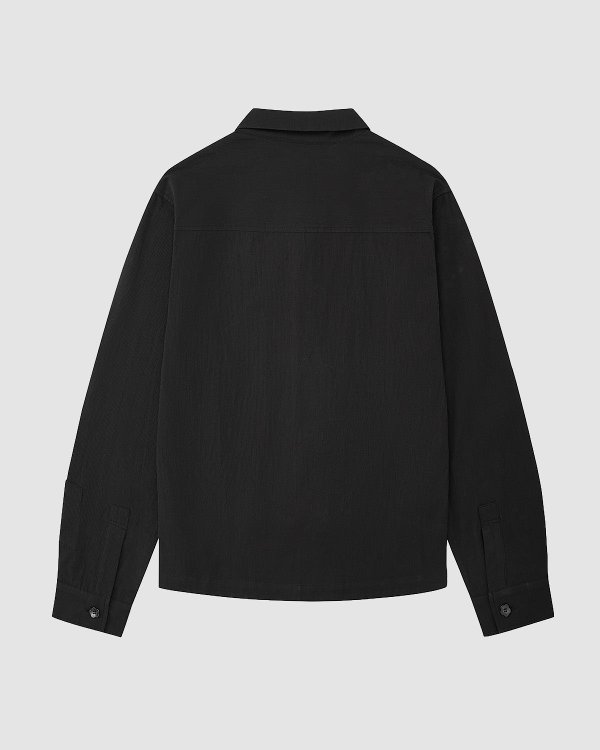 The BLACK CHINA COLLAR KNOT SHACKET by Sundae School is a long-sleeved black shirt with a collar and buttoned cuffs, shown from the back on a plain light gray background.