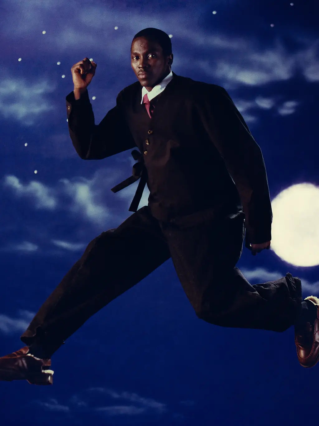 A male model wearing Sundae School Hanbok Tie Blazer and Hanbok Balloon Pants jumping into the night sky