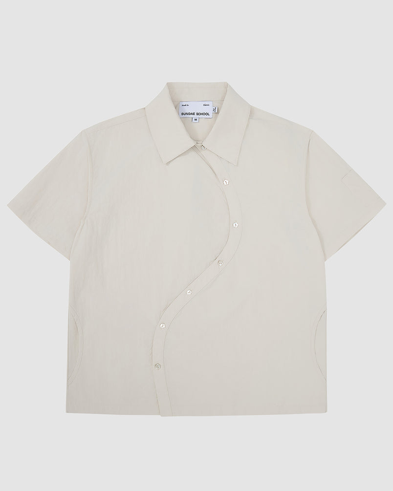 Off-white Ivory Yin Yang Short Sleeve Shirt with asymmetrical curved button placket, classic collar, and short sleeves.