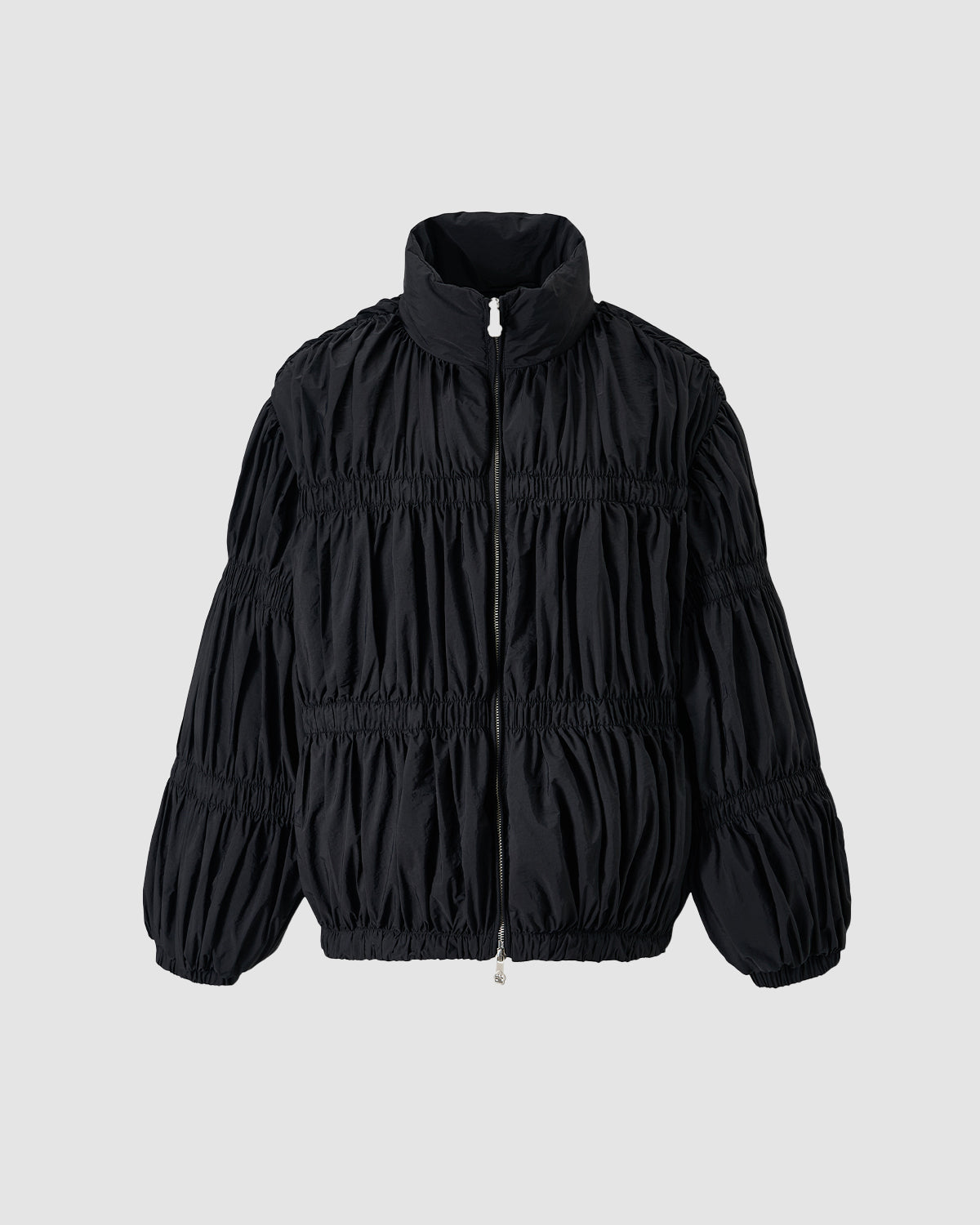 The BLACK PLEATED DUVET PUFFER by Sundae School is a black, long-sleeve jacket with pleats, a high collar, zipper closure, ruched texture, elastic cuffs, and a relaxed fit for cozy warmth.