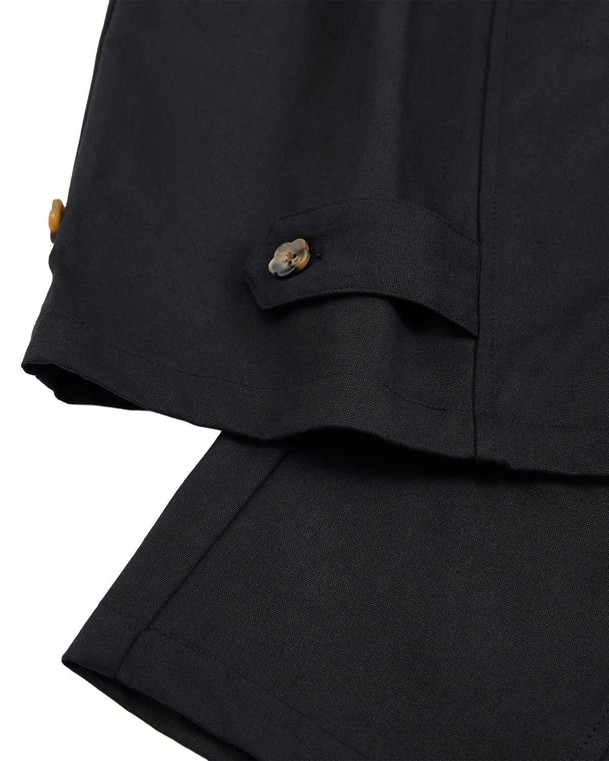 Close-up of Sundae School’s BLACK HANBOK BALLOON PANTS, showcasing the 100% cotton fabric, folded hem with visible stitching, and a tab detail near the edge adorned with two small brown buttons—highlighting subtle hanbok-inspired design elements.