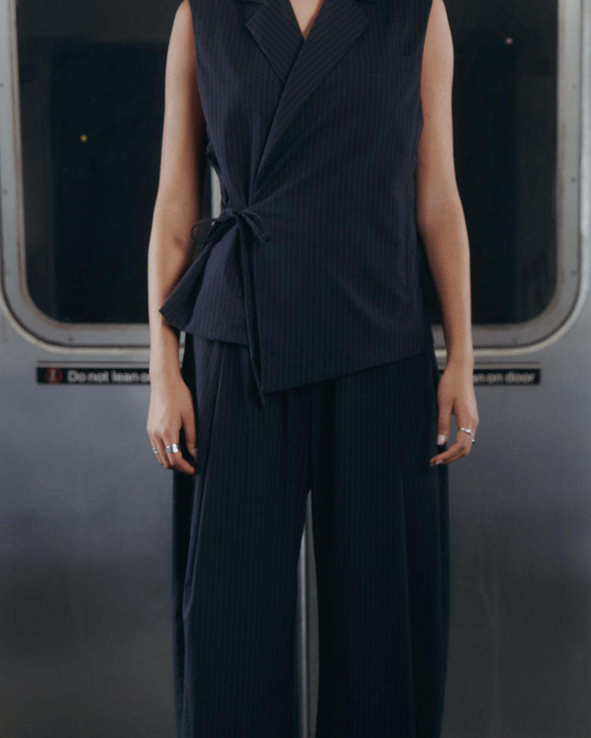 A model wearing SUNDAE SCHOOL SABRINA VEST and KIKI DRAWSTRING SLACKS