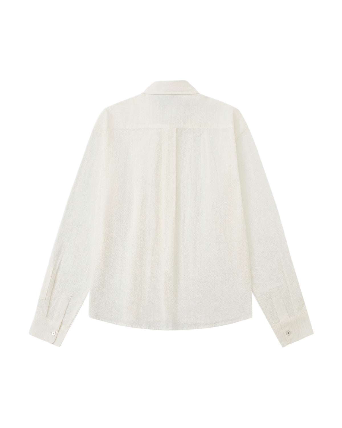 A back flat-lay view of an off-white long-sleeve shirt set against a plain white background, highlighting a shoulder yoke seam, a box pleat running down the center back, and long sleeves with buttoned cuffs.