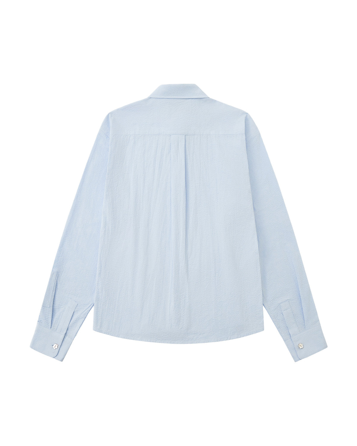 A back flat-lay view of a light blue long-sleeve shirt laid flat against a white background, showing a clean shoulder yoke, a central back box pleat, and buttoned cuffs.
