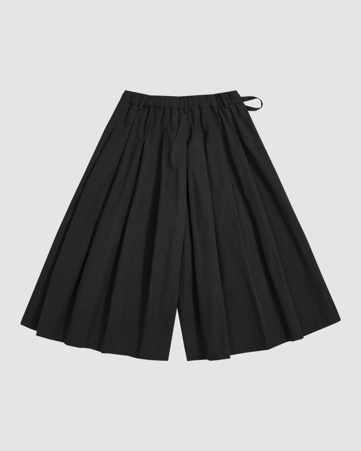 Sundae School's BLACK PLEATED HANBOK CULOTTES, featuring a wide-leg silhouette and elastic waistband, are displayed flat against a plain, light background.