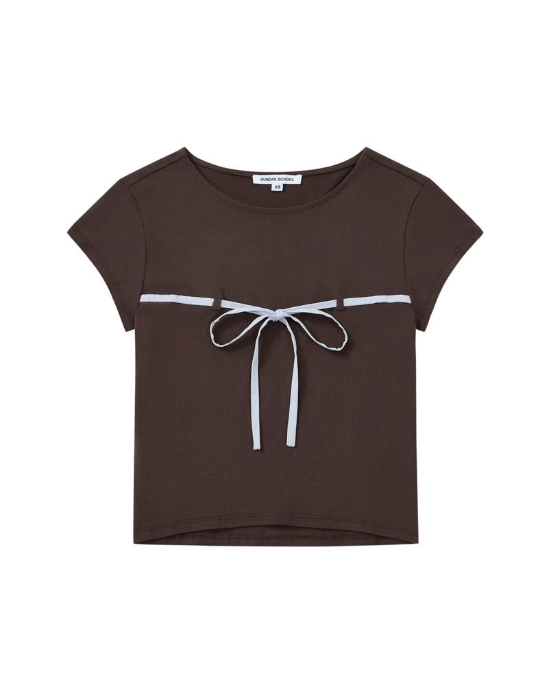 The BROWN TIE GORUM BABY TEE by Sundae School is a short-sleeved, dark brown cropped baby tee featuring a scooped neckline and a light blue bow strap tied across the chest.