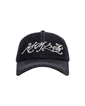 Introducing the INDIGO DAENGGI CAP by Sundae School: a black denim baseball cap adorned with white embroidered graffiti-style text on the front and an embroidered Hangeul logo. Designed for comfort with an adjustable fit, this cap is complemented by distinctive white stitching along the brim and panels.