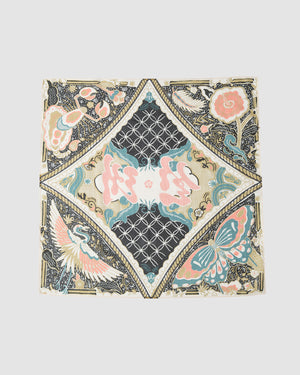 The MULTI-COLOR BATIK BANDANA by Sundae School features detailed flowers, a crane, and a butterfly in pink, blue, cream, and black—symmetrically arranged on a light background and inspired by Indonesian batik.