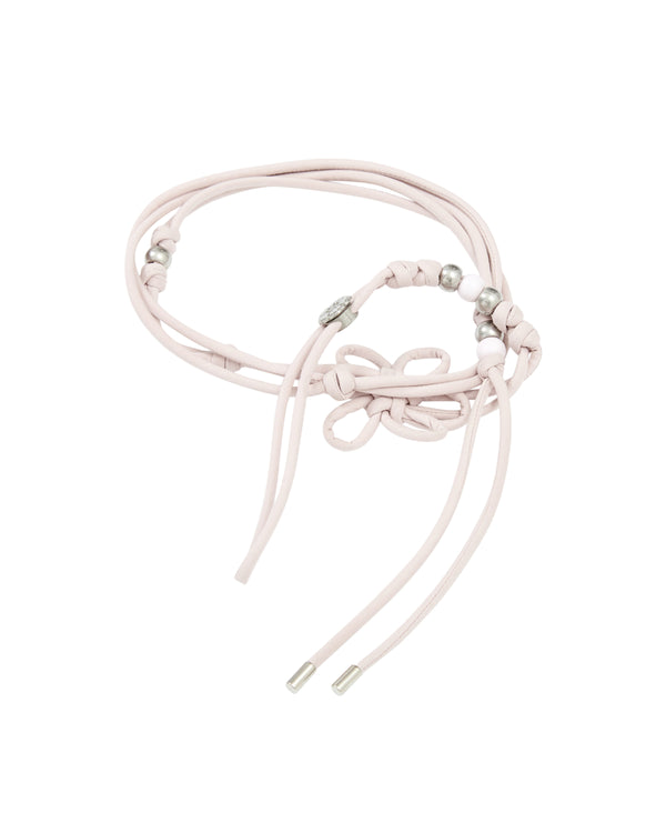 The BABY PINK MAEHWA MACRAME BELT by Sundae School features a light pink hue with silver beads and metal tips, accented by decorative knots and loops that highlight heritage texture accessory details for a refined touch.