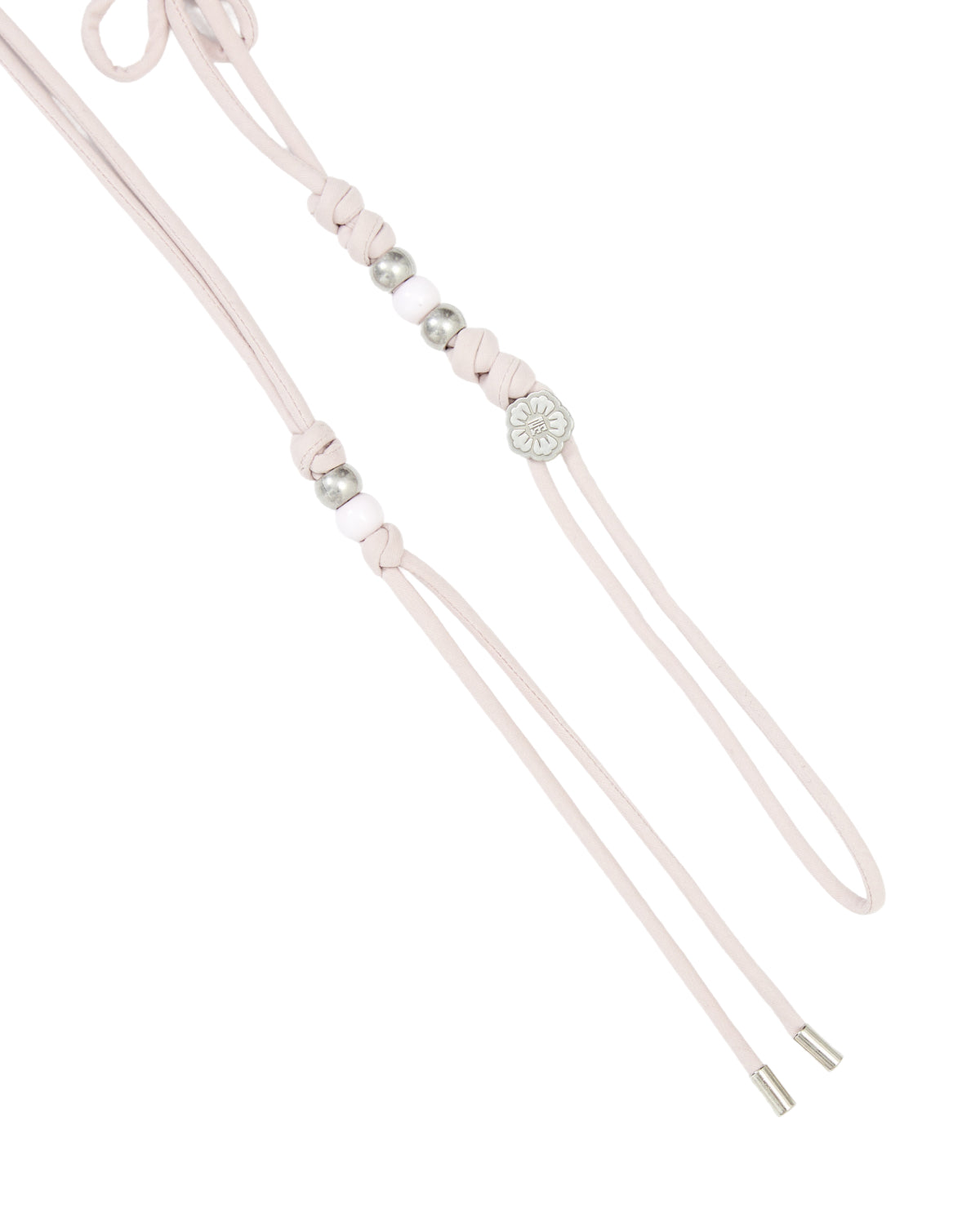 Introducing the BABY PINK MAEHWA MACRAME BELT by Sundae School: this distinctive accessory features a delicate baby pink macrame design accented with silver details and a round, flower-inspired centerpiece. Heritage-inspired texture and elegant silver cord tips complete its refined look.