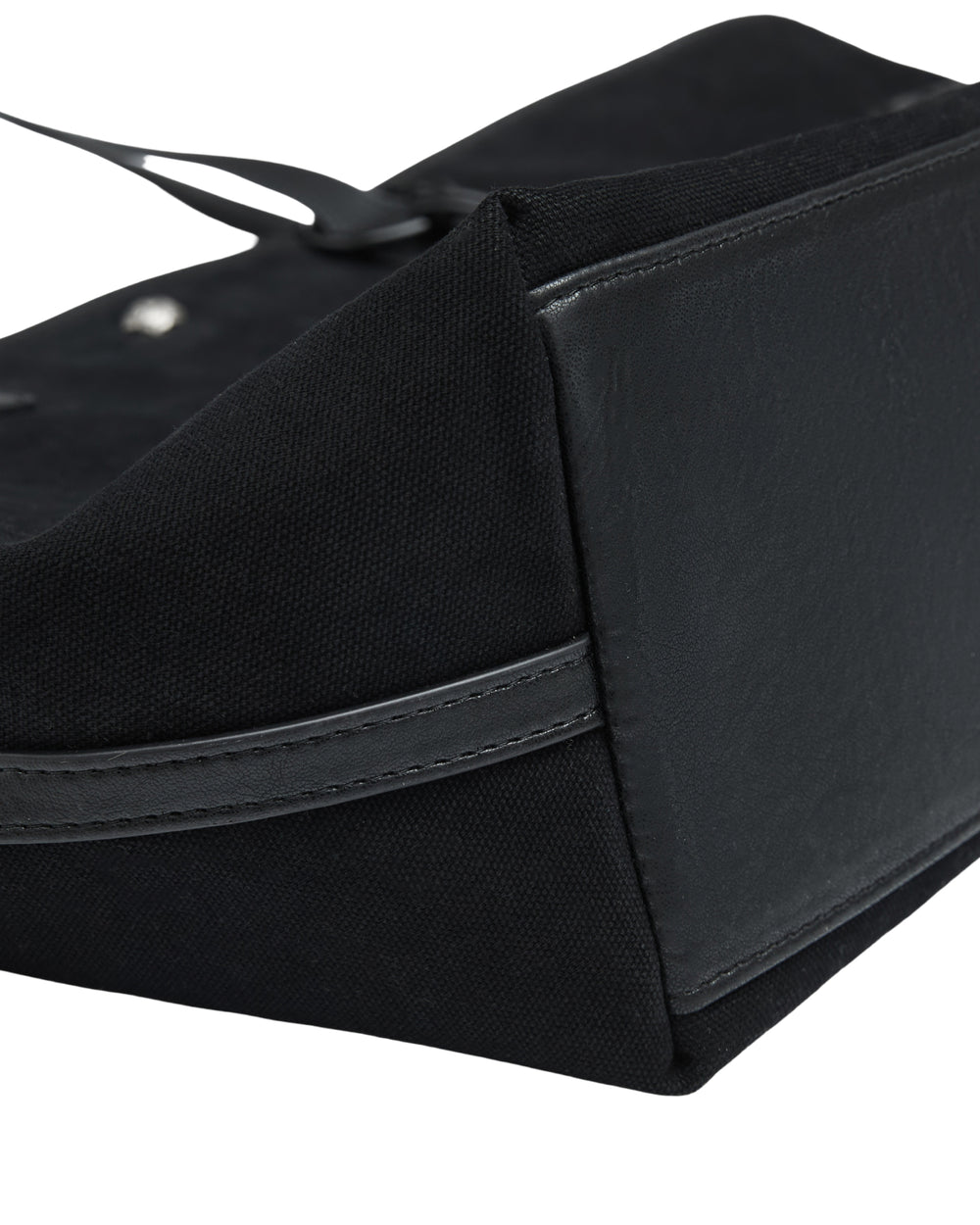 Close-up of a BLACK BOJAGI TIE TOTE BAG corner, showing a textured fabric body, a smooth base panel, and strap detail.