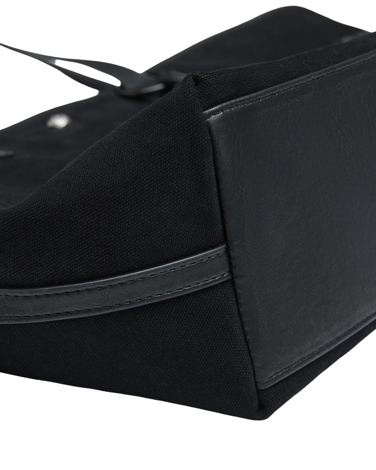 Close-up of a BLACK BOJAGI TIE TOTE BAG corner, showing a textured fabric body, a smooth base panel, and strap detail.