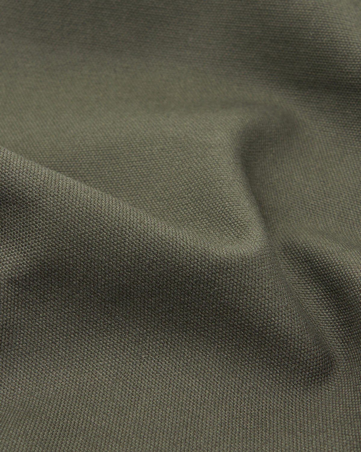 A close-up of the Sundae School OLIVE BOJAGI TIE TOTE BAG shows its olive green, textured woven fabric and soft folds, emphasizing the bag’s distinctive foldable design.