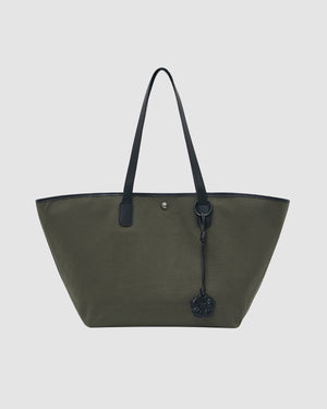 The OLIVE BOJAGI TIE TOTE BAG by Sundae School is a large olive green tote with black vegan leather trim, handles, and a black keychain charm on one handle, shown against a plain light background.
