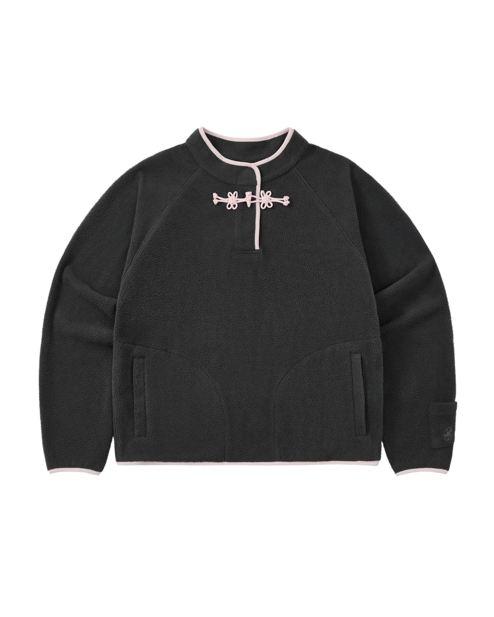 The CHARCOAL BUTTERFLY FLEECE PULLOVER by Sundae School is a black polar fleece sweater with light pink trim, featuring a mandarin collar adorned with decorative hand-tied flower knots at the neck. This mock-neck pullover offers two front pockets and a relaxed, casual fit.