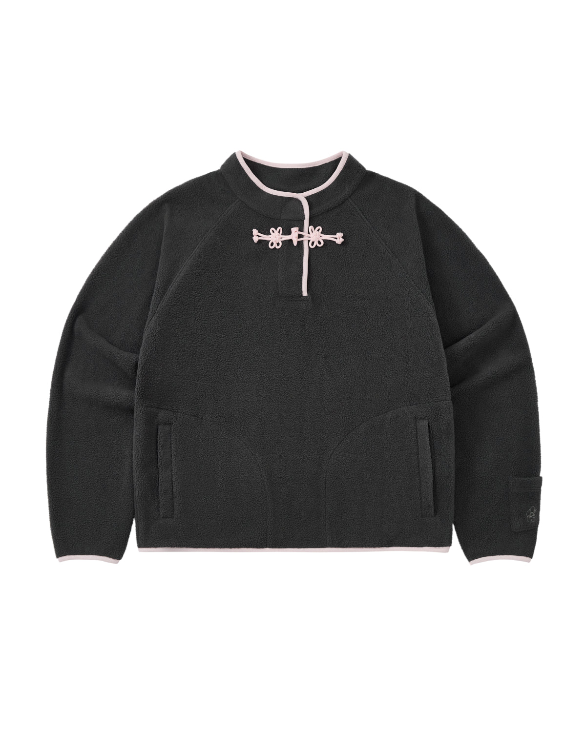 The CHARCOAL BUTTERFLY FLEECE PULLOVER by Sundae School is a black polar fleece sweater with light pink trim, featuring a mandarin collar adorned with decorative hand-tied flower knots at the neck. This mock-neck pullover offers two front pockets and a relaxed, casual fit.