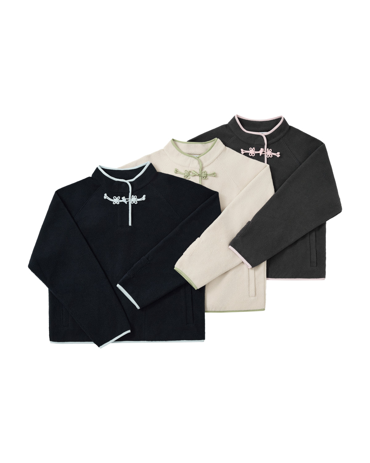 Three Sundae School TAUPE BUTTERFLY FLEECE PULLOVERS are layered on top of each other in black, beige, and off-white colors against a white background, each featuring a mandarin collar and decorative hand-tied flower knots.