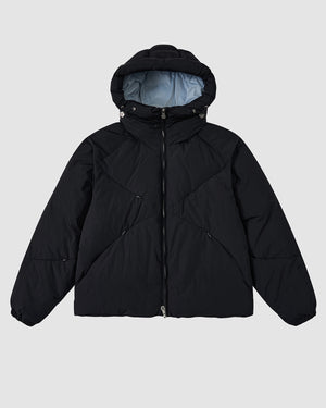 The Sundae School BLACK SKY BLUE ORIGAMI PUFFER is a black hooded jacket with a front zipper, light blue inner lining, and elasticated cuffs, shown against a plain light grey background.