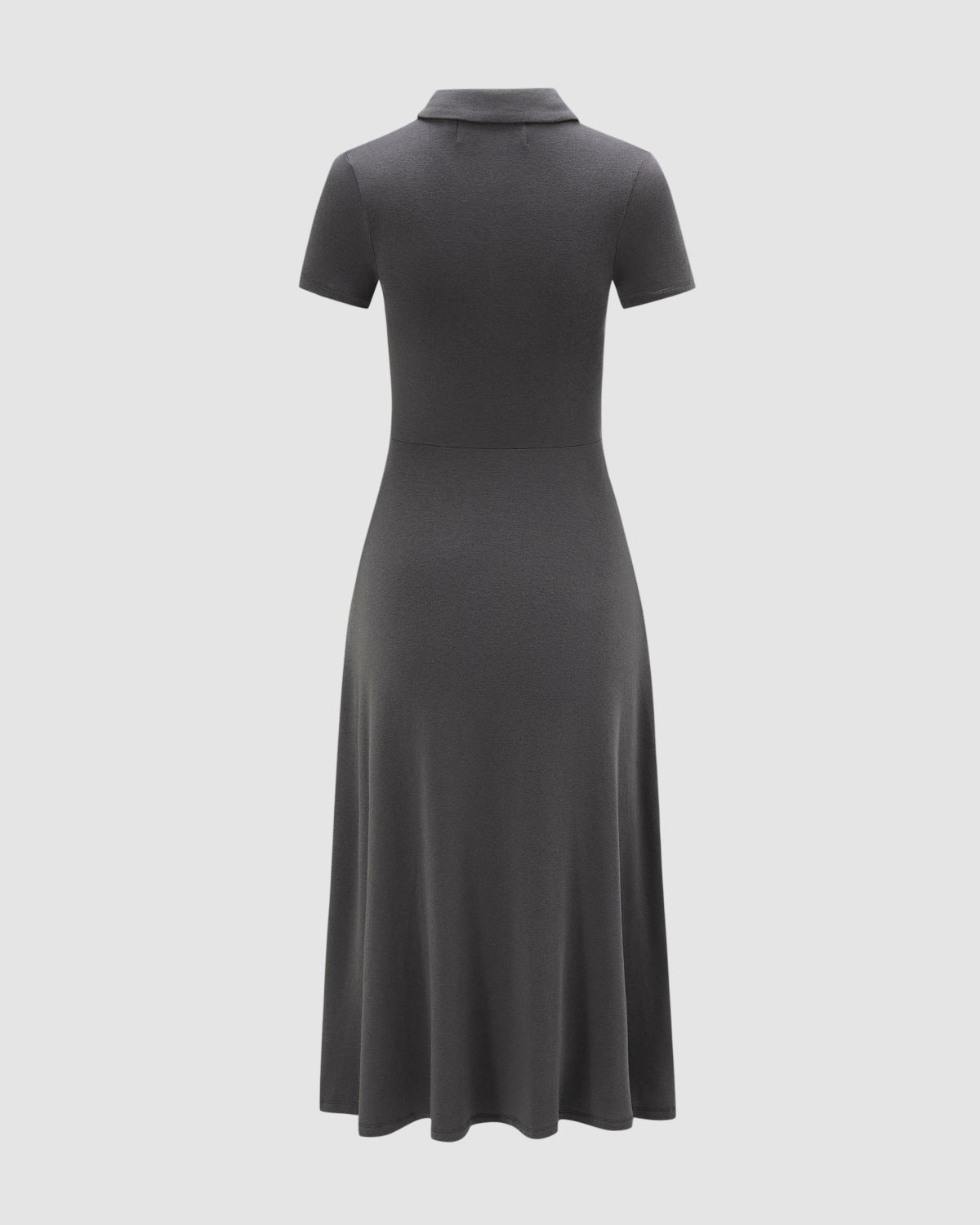 A back view of the DARK GREY CINDY POLO DRESS by Sundae School—a short-sleeve, dark gray collared convertible apron dress featuring a fitted bodice and flared skirt—showcased against a plain light background.