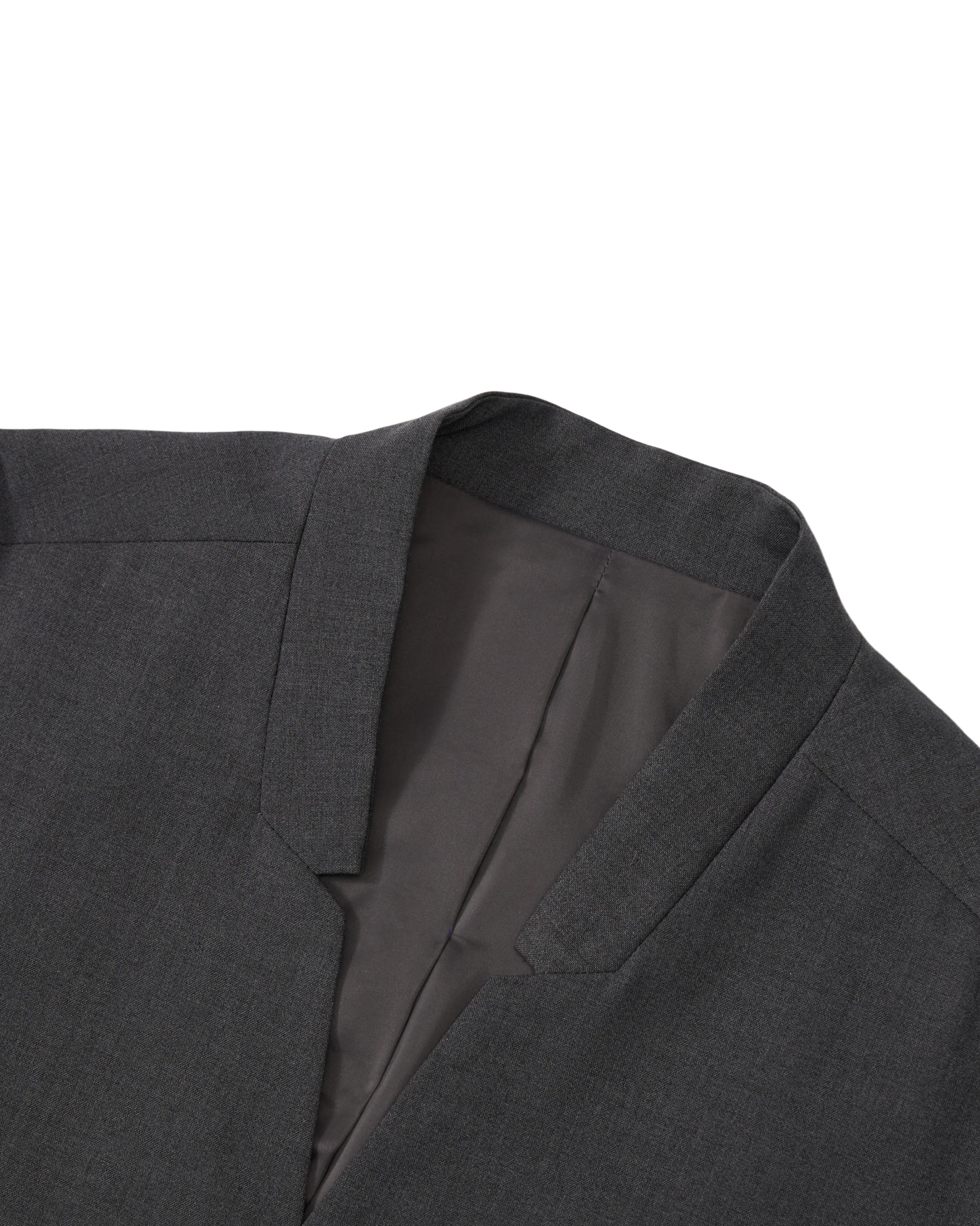 A close-up of the COLLARLESS TIE BLAZER by Sundae School displays the refined collar and lapel against a white background, showcasing the inner lining and precise tailoring that emphasize its unstructured drape for a contemporary, effortless silhouette.