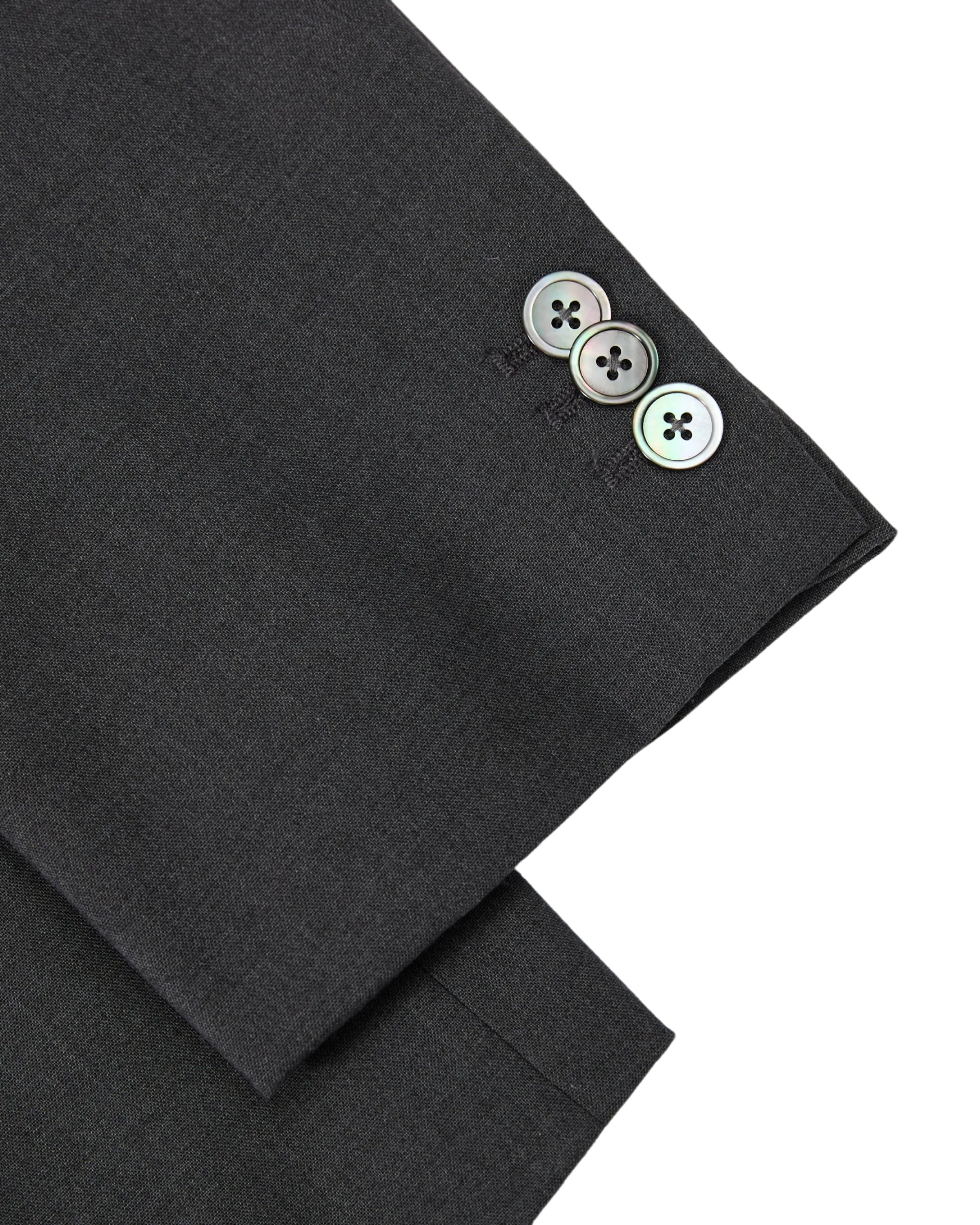 A close-up of the Sundae School COLLARLESS TIE BLAZER’s sleeve showcases three shiny buttons neatly stacked near the cuff, highlighting the dark, collarless summer wool design.