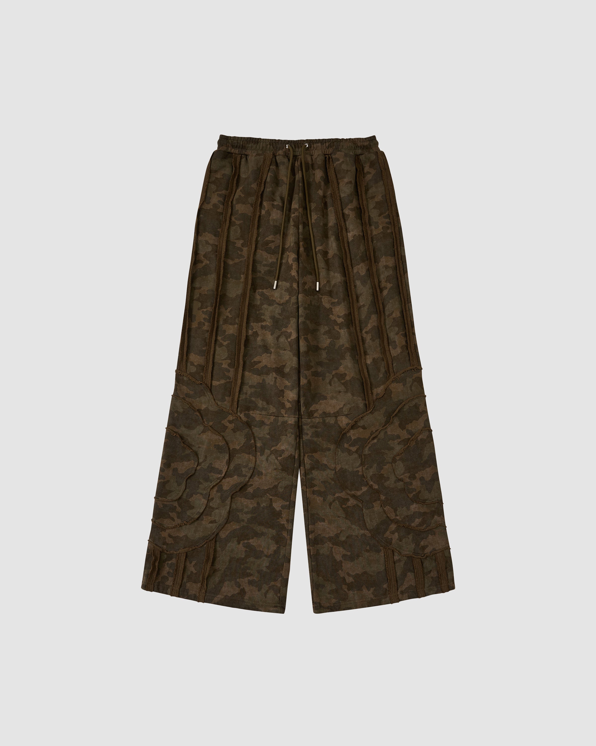 The Sundae School CAMO MOCHI HAZE PANELED SWEATPANTS feature wide-leg 100% cotton, an elastic waistband with drawstring, large patch pockets, a dark green and brown camo print, and decorative leg seam details.