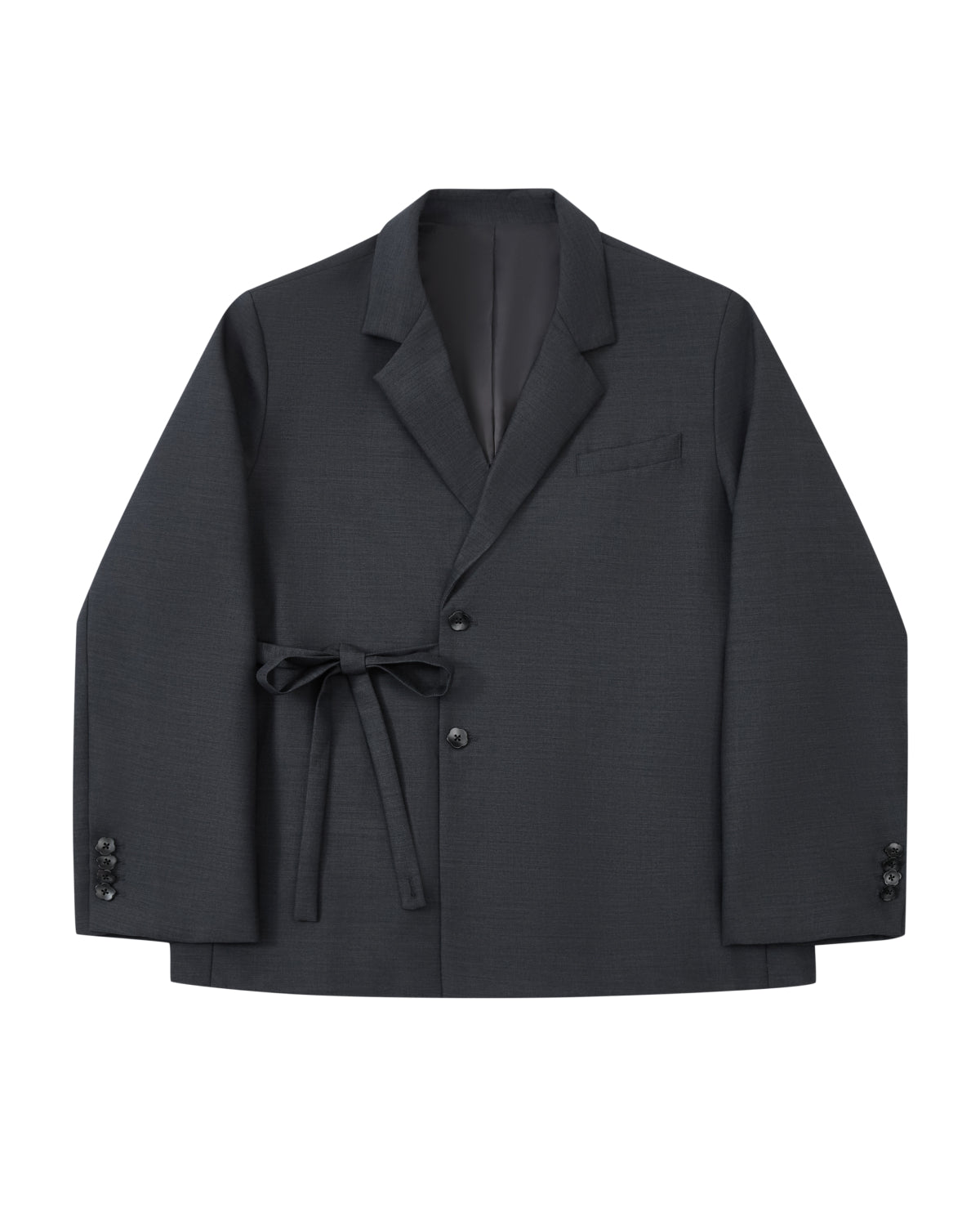 Introducing the CHARCOAL DOUBLE DUTY BLAZER by Sundae School—a refined wool blend blazer in deep charcoal, featuring notched lapels, front button closure, a chest pocket, and a fabric belt elegantly tied at the waist. Inspired by the silhouette of a hanbok, this design is finished with subtle button accents near the cuffs for an elevated touch.