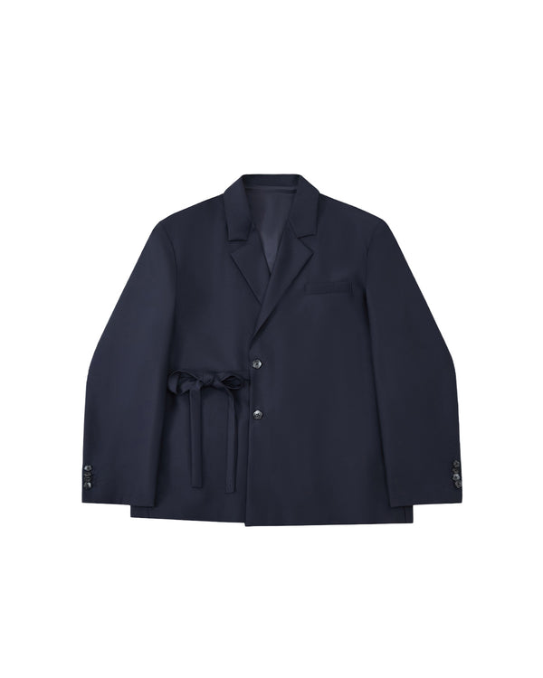 The Sundae School NAVY DOUBLE DUTY BLAZER, a navy wool blend with notched lapel, front buttons, chest pocket, and hanbok-inspired fabric belt at the waist, is displayed flat on a light gray background.