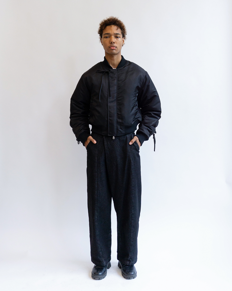 A model wearing Sundae School Black Flower Channeled Bomber against a white background.