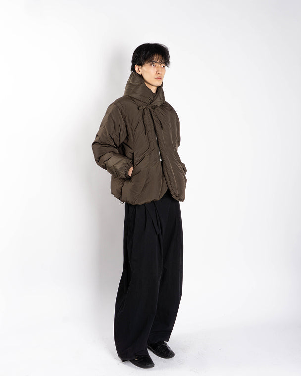 The Sundae School KHAKI HEAVYWEIGHT MOCHI PUFFER is a Korean hanbok-inspired olive green hooded jacket with quilted stitching, front bow tie closure, and elasticated cuffs, shown against a plain light gray background.