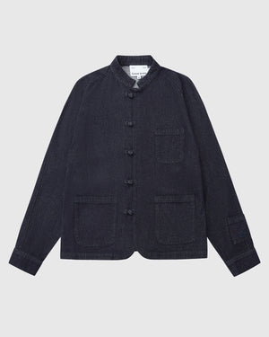The Sundae School DENIM CHORE JACKET features dark denim, a mandarin collar, three front patch pockets, a button-up front, and long sleeves, shown laid flat on a white background.