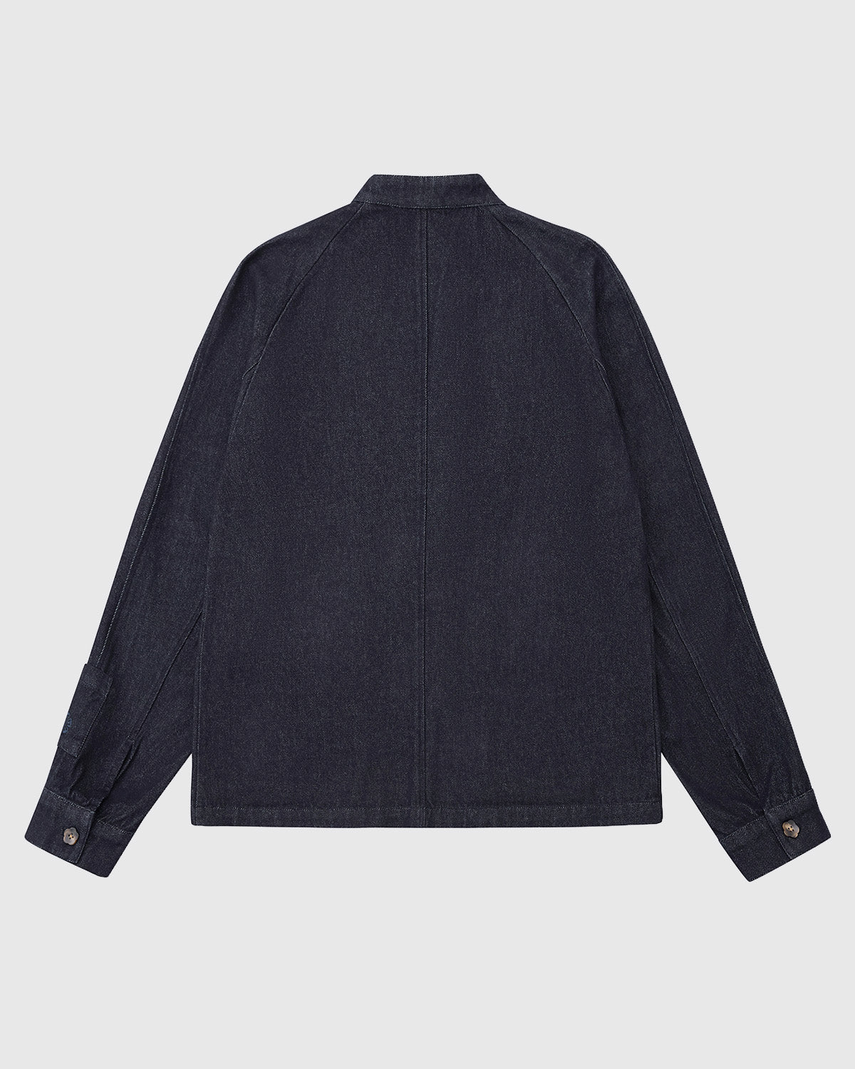 The DENIM CHORE JACKET by Sundae School is shown from the back with long sleeves, a straight hem, center seam, and buttoned cuffs, photographed against a plain white background.