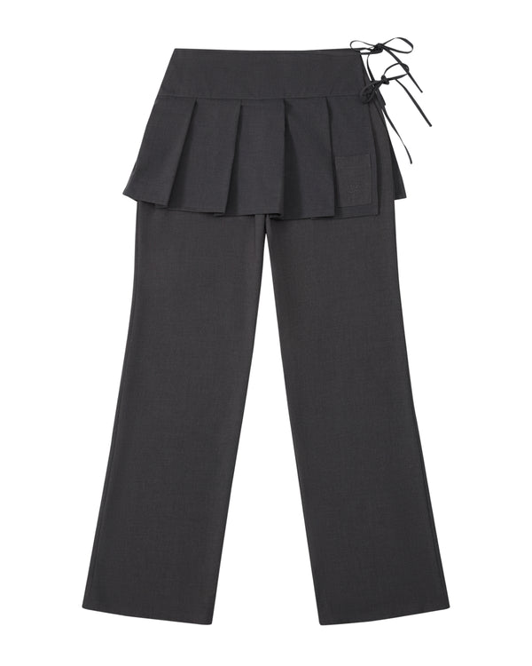 The FLARE SKIRT PANTS by Sundae School are crafted from dark gray wool tencel and feature a pleated apron skirt overlay at the waist with a side tie detail. These semi-bootcut trousers boast a straight-leg silhouette and include a small pocket on the skirt section for added functionality and style.