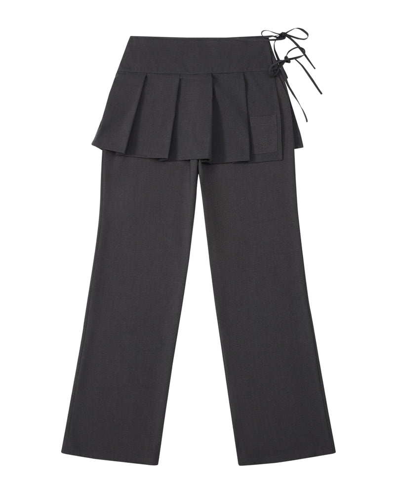 The FLARE SKIRT PANTS by Sundae School are crafted from dark gray wool tencel and feature a pleated apron skirt overlay at the waist with a side tie detail. These semi-bootcut trousers boast a straight-leg silhouette and include a small pocket on the skirt section for added functionality and style.