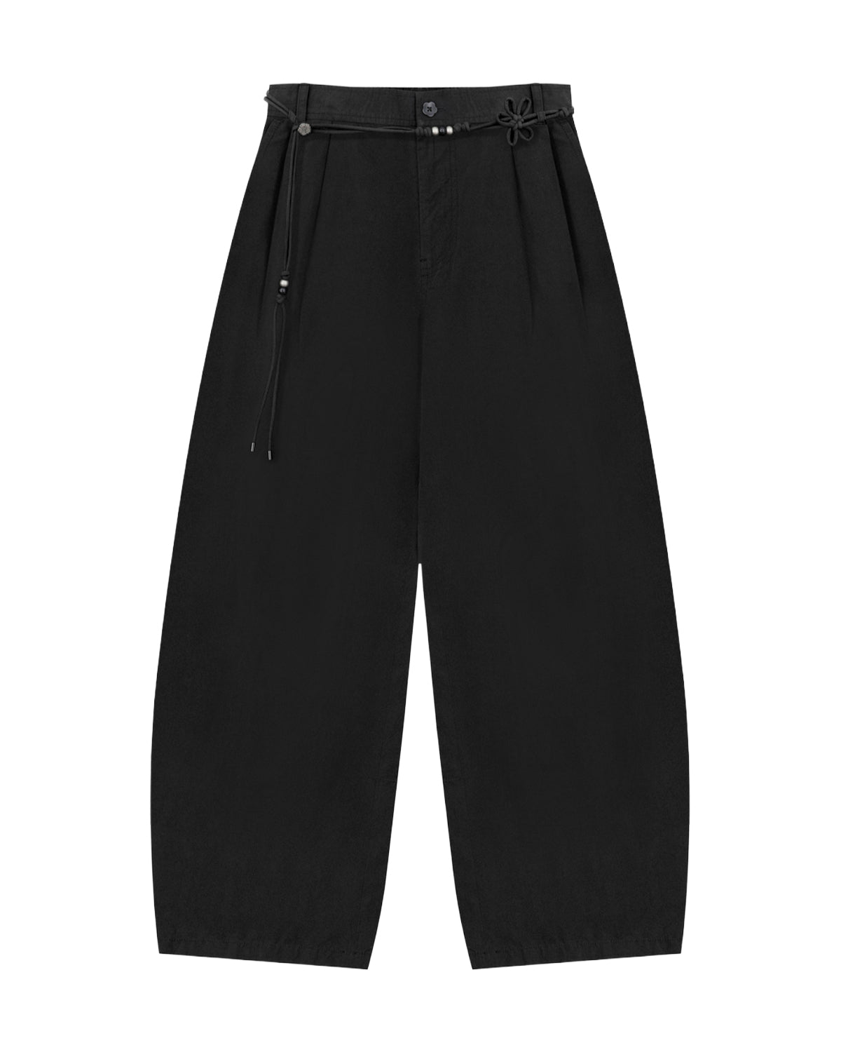 The BLACK FLOWER NORIGAE LINEN TROUSERS by Sundae School are wide-leg, high-waisted black pants with pleats at the top and a thin decorative norigae belt featuring a knotted detail on the right side. These Korean-inspired trousers are laid flat on a white background.