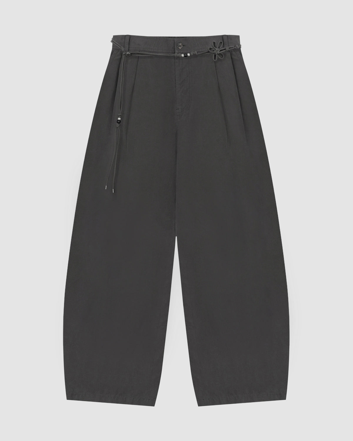 The CHARCOAL FLOWER NORIGAE LINEN TROUSERS by Sundae School are wide-leg black trousers inspired by Korean fashion, featuring a high waist, pleated front, and a thin belt with a knotted detail and small metallic accents, shown flat against a plain light background.