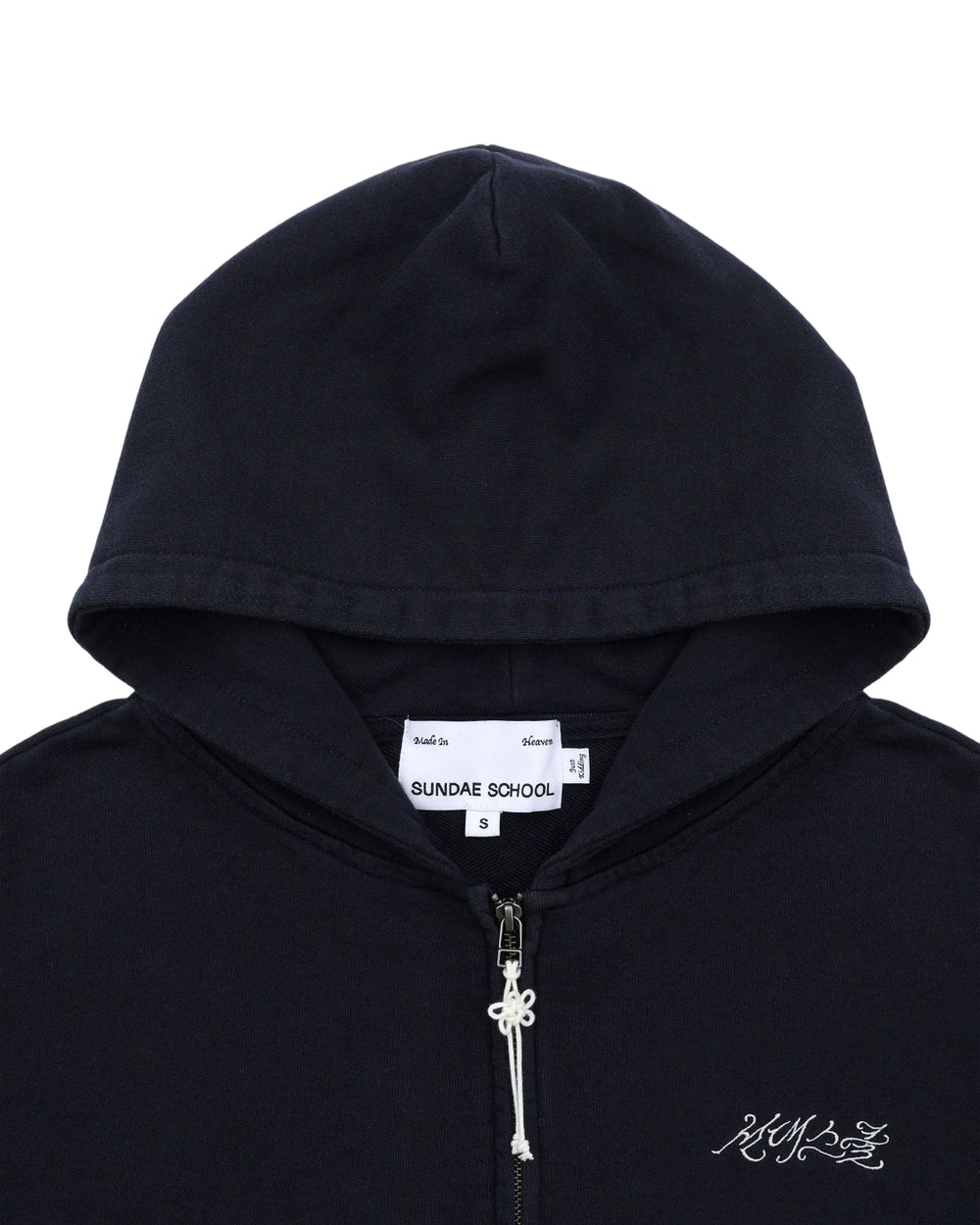 NAVY WASH FLOWER KNOT ZIP UP by Sundae School: Navy cotton zip-up hoodie with a hood up, partially unzipped. The inner label displays "Sundae School" and size S, while white Hangul "Sundae School" embroidery accents the left chest. A subtle Maehwa knot detail provides a unique finishing touch to the design.